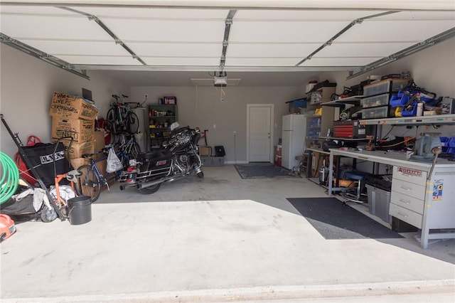 4130 Vintage Estates Ct, Bryan, TX 77808 - garage featuring freestanding refrigerator and a garage door opener