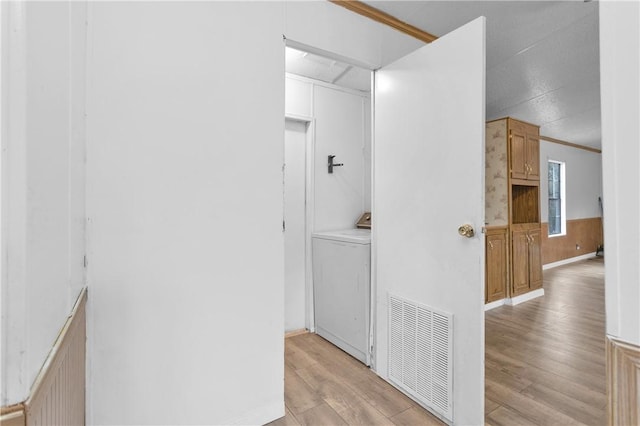 SPLITA4794 Tall Pine Rd, Navasota, TX 77868 - corridor featuring washer / clothes dryer, light wood-type flooring, and a wainscoted wall