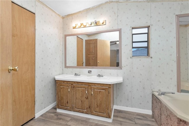 SPLITA4794 Tall Pine Rd, Navasota, TX 77868 - full bathroom with wood finished floors, double vanity, a bathtub, and wallpapered walls