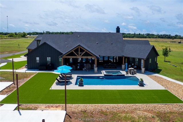 view of pool with a lawn, outdoor lounge area, an in ground hot tub, and a patio