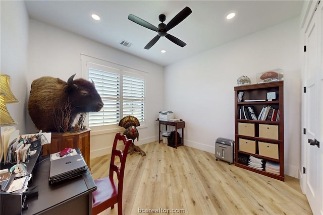 office space featuring ceiling fan and light wood-type flooring