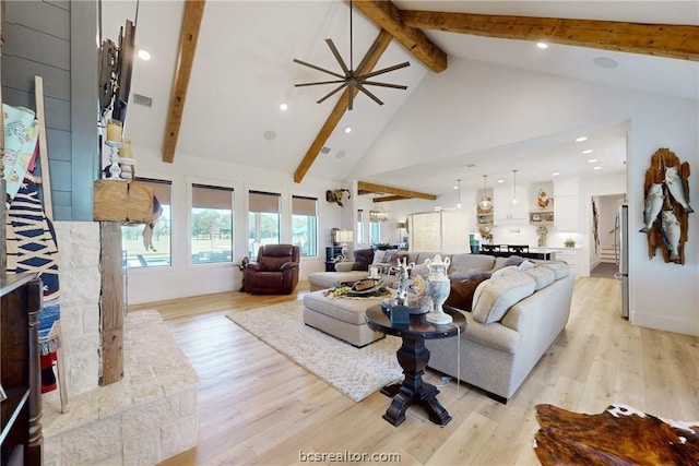 living room with beamed ceiling, high vaulted ceiling, and light hardwood / wood-style flooring