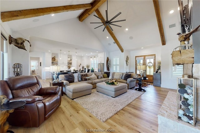 living room with ceiling fan, light hardwood / wood-style floors, beam ceiling, and high vaulted ceiling