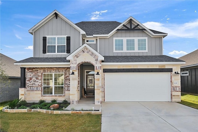 view of front of property with a front yard and a garage