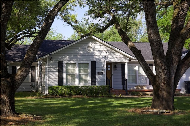 306 Timber St, College Station, TX 77840 - view of front of house with a front lawn and a shingled roof