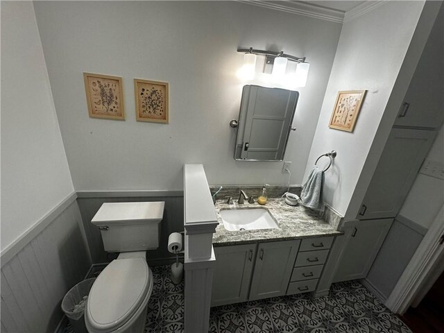 306 Timber St, College Station, TX 77840 - half bathroom with ornamental molding, vanity, toilet, and wainscoting