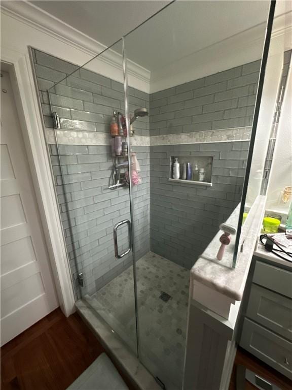 306 Timber St, College Station, TX 77840 - bathroom featuring ornamental molding, a stall shower, and wood finished floors