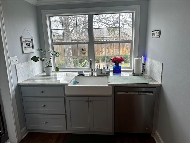 306 Timber St, College Station, TX 77840 - kitchen featuring dishwasher, a sink, plenty of natural light, ornamental molding, and dark wood-style floors