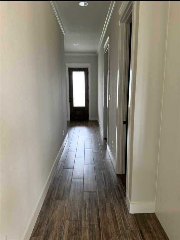 2913 Bombay Ct, Bryan, TX 77808 - hallway featuring crown molding, dark wood finished floors, and recessed lighting