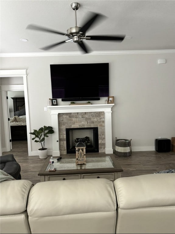 2913 Bombay Ct, Bryan, TX 77808 - living room with crown molding, ceiling fan, wood finished floors, and a fireplace with raised hearth