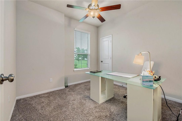 unfurnished office with baseboards, a ceiling fan, and light colored carpet
