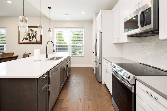 293 Estates Cir, College Station, TX 77840 - kitchen with appliances with stainless steel finishes, a sink, dark wood-style flooring, light countertops, and recessed lighting