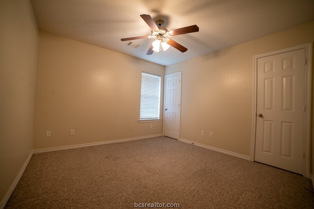 empty room with carpet and ceiling fan