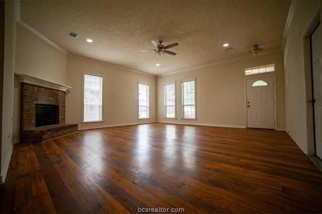 unfurnished living room featuring a fireplace, dark hardwood / wood-style flooring, ceiling fan, and ornamental molding