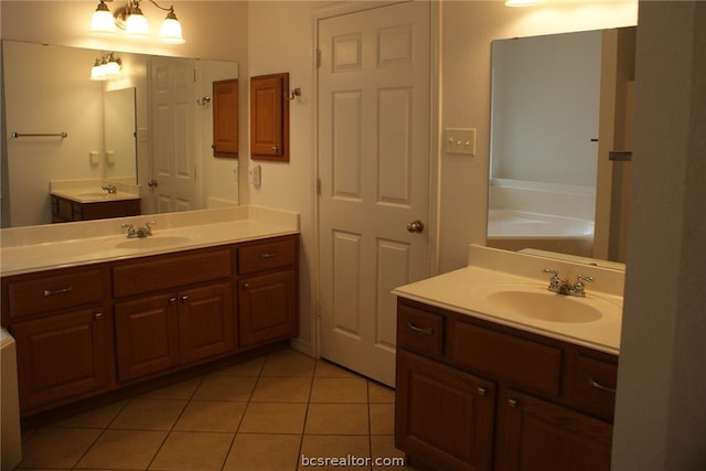 bathroom featuring tile patterned floors, vanity, and a bath