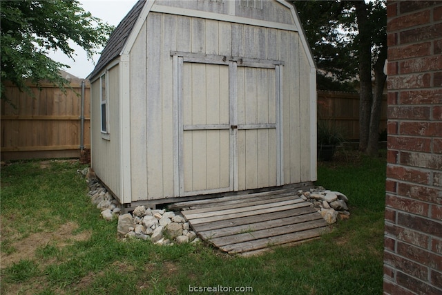 view of outbuilding featuring a lawn