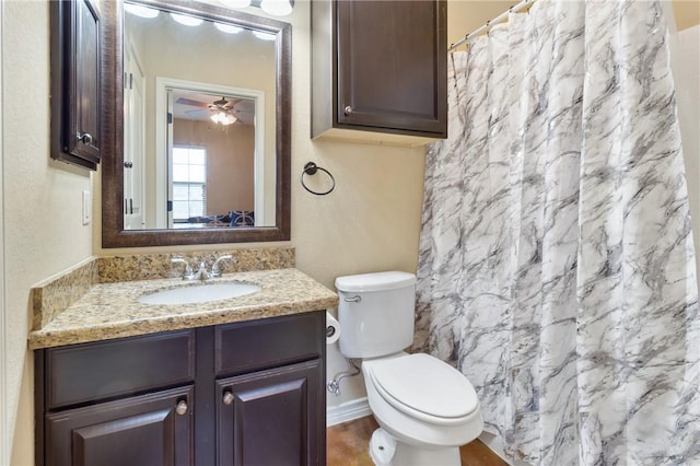 bathroom with toilet, vanity, and a shower with shower curtain