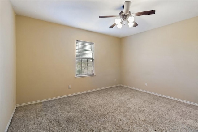 empty room featuring ceiling fan and carpet