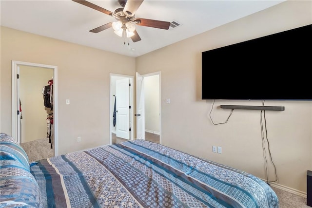 bedroom with carpet floors, a closet, a spacious closet, and ceiling fan