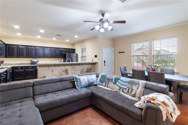 living room with ceiling fan and ornamental molding