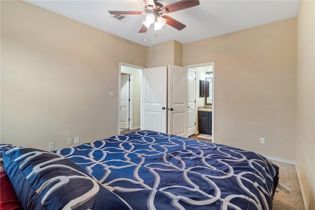 bedroom featuring ceiling fan, carpet, and ensuite bath