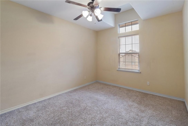 carpeted spare room with ceiling fan