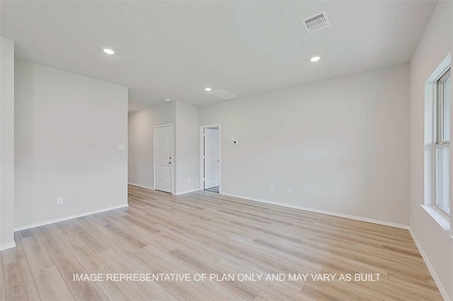 spare room with light hardwood / wood-style flooring