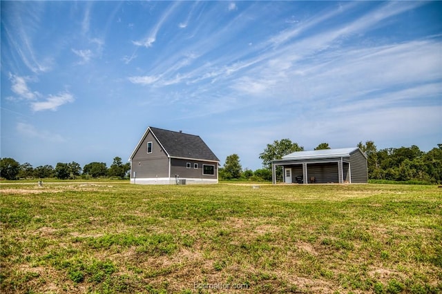 view of yard with a rural view and an outdoor structure