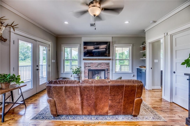 living room featuring a healthy amount of sunlight, french doors, ceiling fan, and light hardwood / wood-style floors