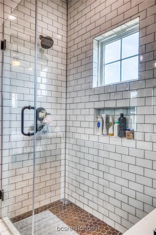 bathroom featuring a shower with shower door