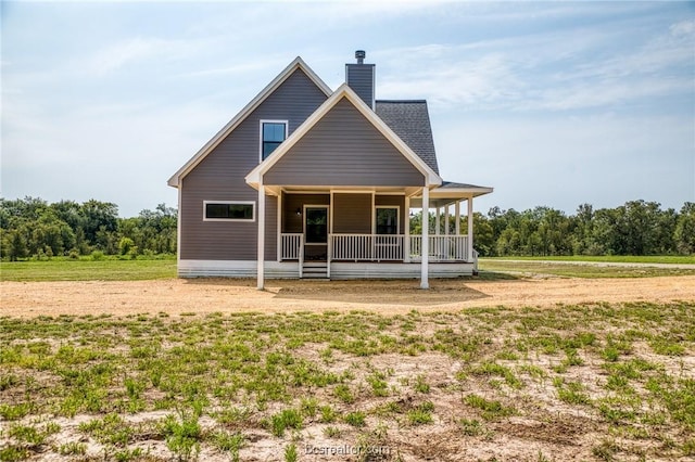 rear view of house with covered porch