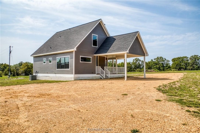 rear view of property featuring cooling unit and a porch