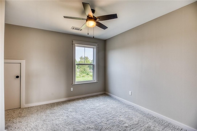 carpeted spare room featuring ceiling fan