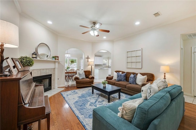3307 Fredrick Ct, College Station, TX 77845 - living room with arched walkways, ceiling fan, hardwood / wood-style floors, ornamental molding, and baseboards