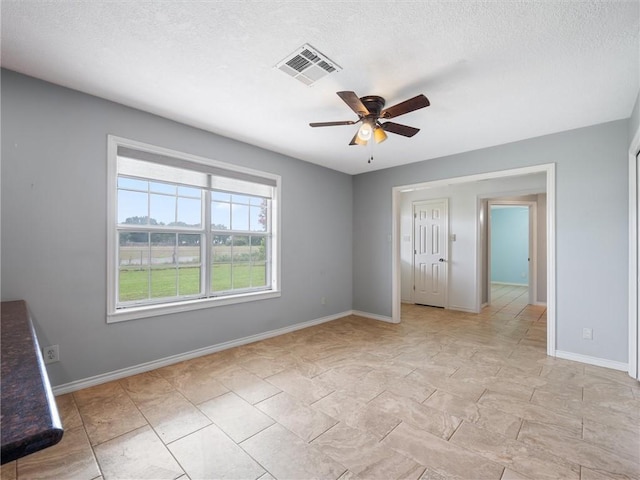 17645 Hwy 6, Navasota, TX 77868 - spare room with a ceiling fan and a textured ceiling