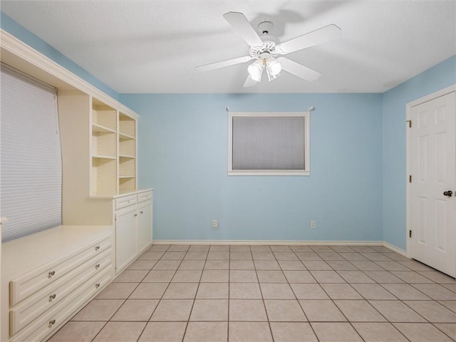 17645 Hwy 6, Navasota, TX 77868 - unfurnished bedroom with a ceiling fan and light tile patterned flooring