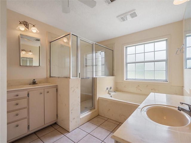 17645 Hwy 6, Navasota, TX 77868 - full bathroom with vanity, a stall shower, a bath, tile patterned floors, and a ceiling fan