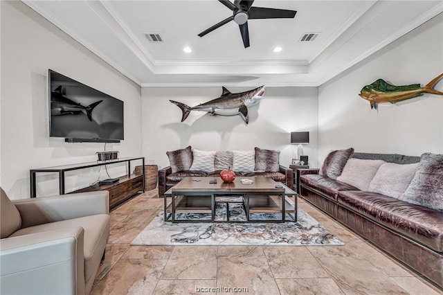 living room with ceiling fan, ornamental molding, and a tray ceiling