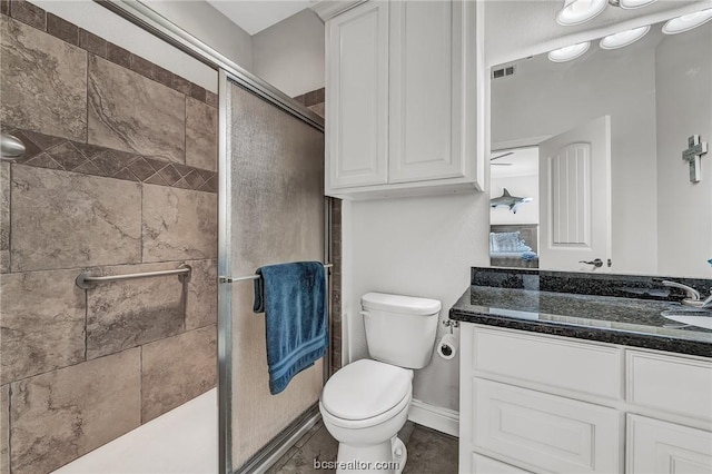 3802 Estes Park, College Station, TX 77845 - bathroom featuring toilet, vanity, and a shower with door
