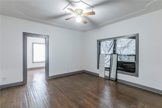 spare room featuring ceiling fan and dark hardwood / wood-style flooring