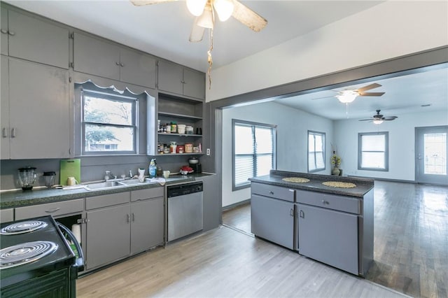 kitchen with gray cabinetry, black electric range oven, stainless steel dishwasher, and light hardwood / wood-style flooring