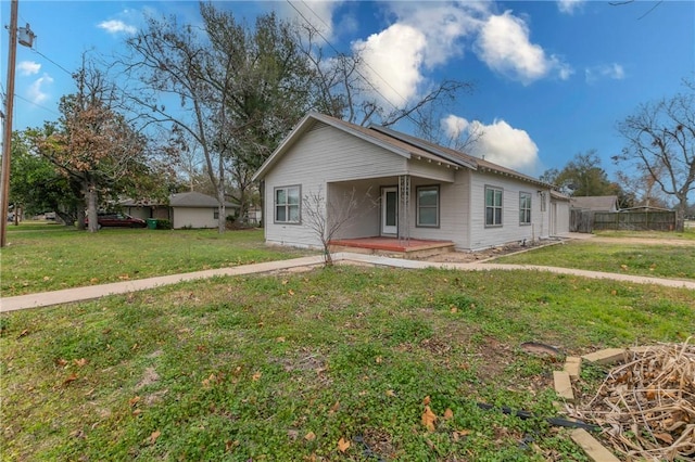 bungalow-style house featuring a front lawn