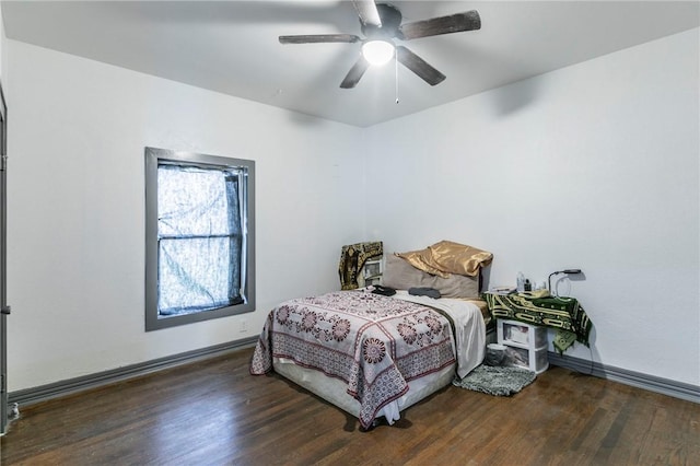 bedroom with ceiling fan and dark hardwood / wood-style flooring