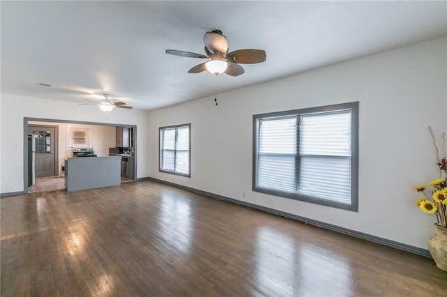 unfurnished living room with ceiling fan and dark hardwood / wood-style flooring