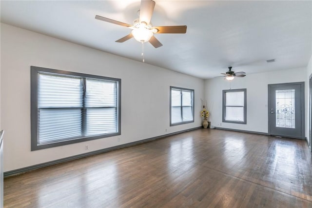 unfurnished room with ceiling fan and dark hardwood / wood-style flooring