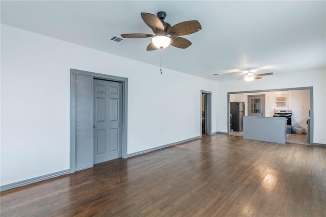 unfurnished living room with ceiling fan and dark wood-type flooring