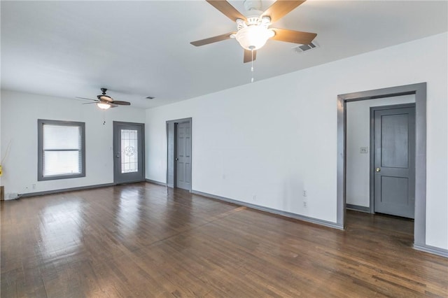 empty room with ceiling fan and dark hardwood / wood-style floors