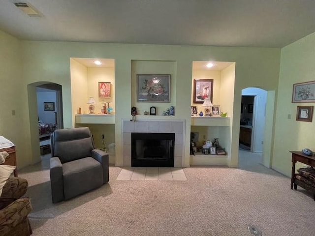 carpeted living room featuring a fireplace