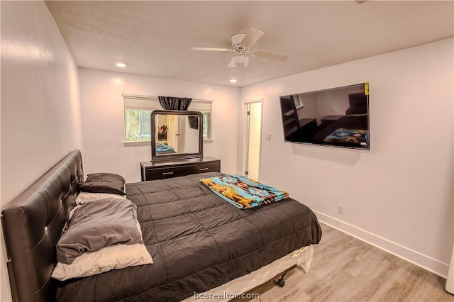 bedroom with ceiling fan and light hardwood / wood-style floors