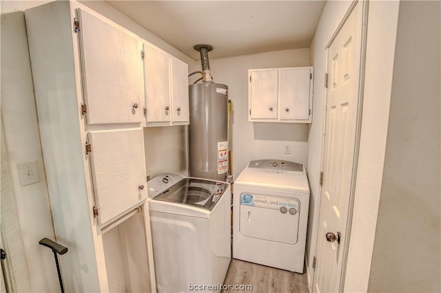 clothes washing area with cabinets, light wood-type flooring, water heater, and washing machine and clothes dryer